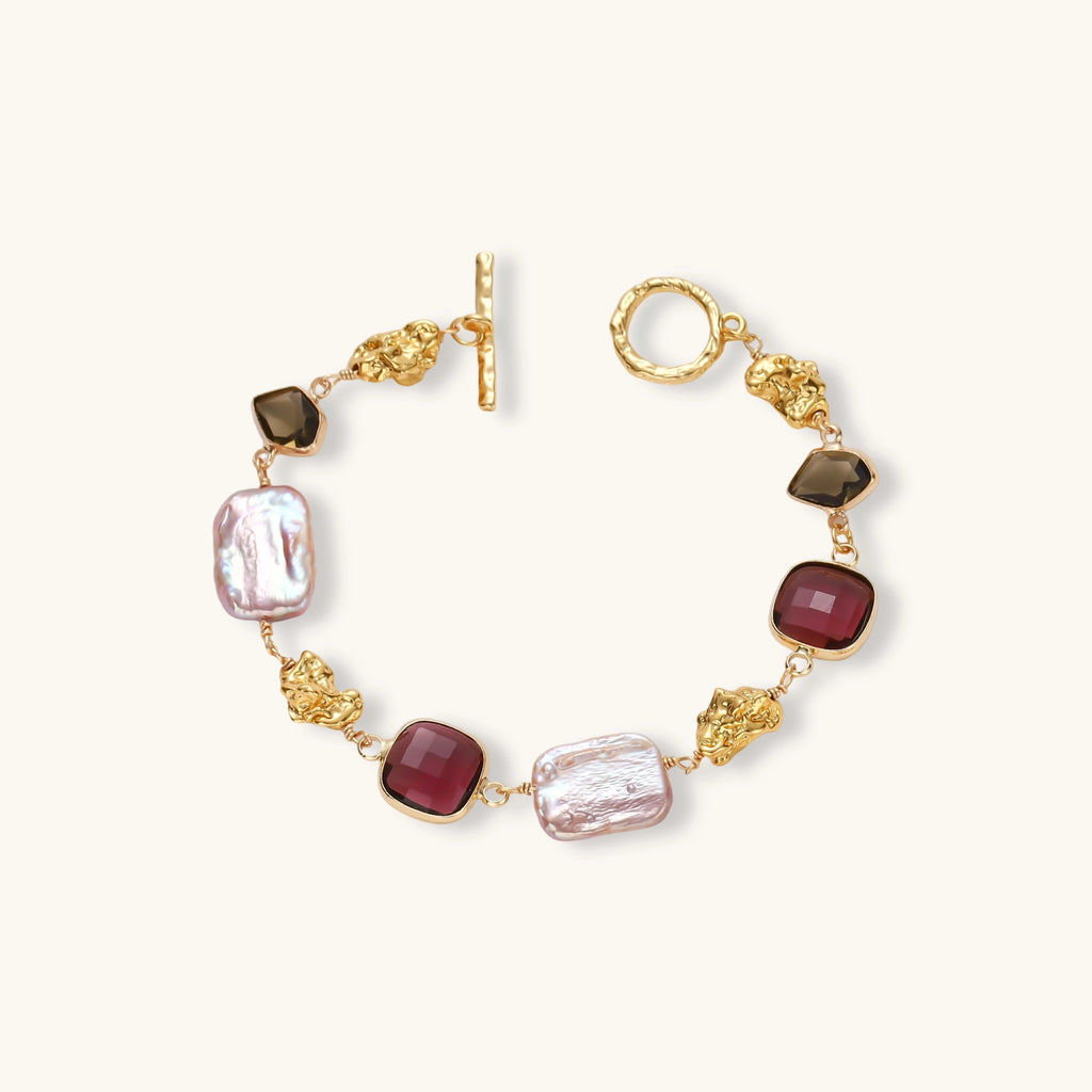 Gold plated toggle bracelet with baroque freshwater pearls, burgundy square stones, smoky brown stones and gold nugget links.